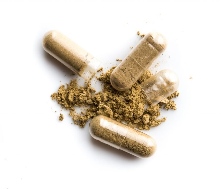 Supplement capsules on a white background.